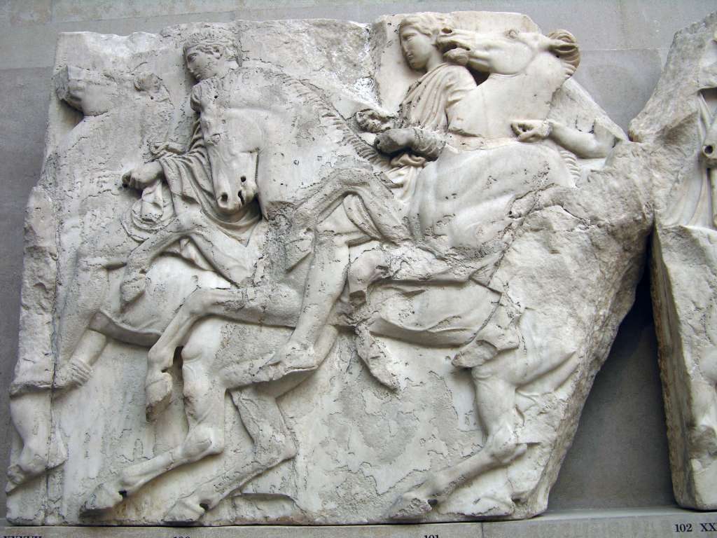 British Museum Top 20 04-1 Elgin Marbles Block 37 4. Parthenon Horsemen block number 37 � Athens Parthenon, 447-432BC. The Elgin Marbles refers to the collection of sculptures from the Parthenon acquired by Lord Elgin between 1801 and 1805. The Parthenon was built as a temple to Athena on the Acropolis of Athens and was decorated with marble sculptures representing scenes from Athenian cult and mythology. This block from the north frieze shows three horsemen holding the reins of their galloping horses tightly in both hands. The first at the left wears a short chiton, chlamys and sandals, the second a double-belted sleeved chiton and sandals, whereas the body of the third at the join of the two blocks is badly damaged.